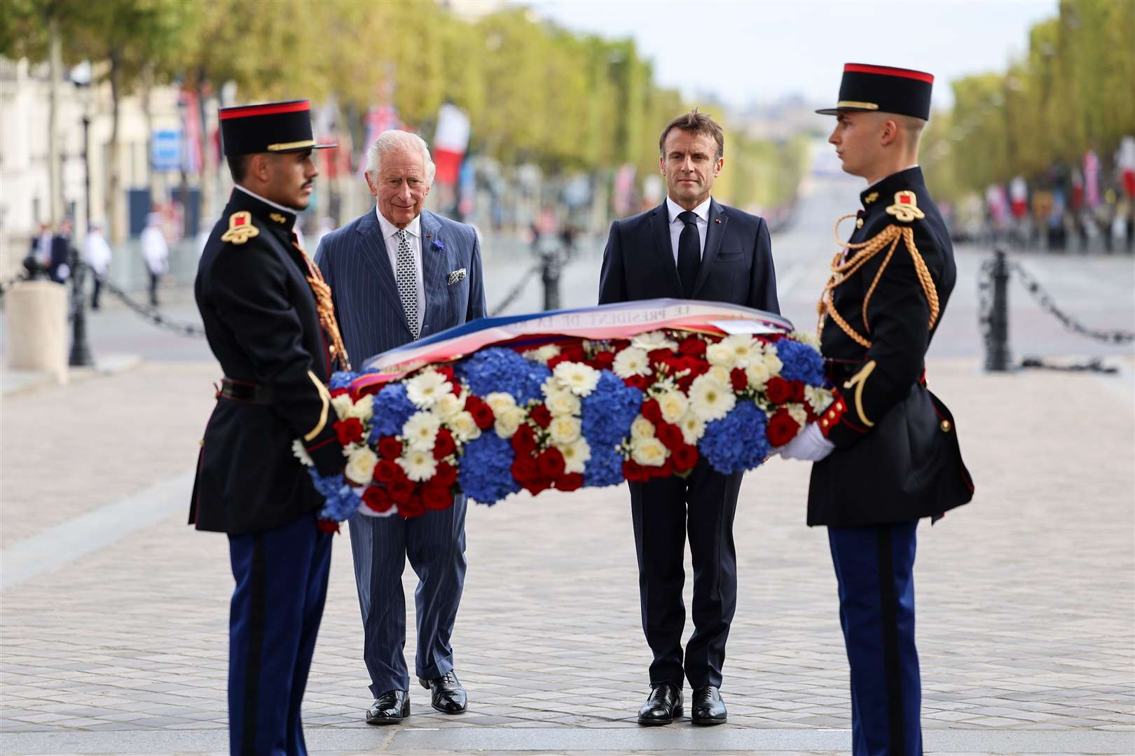The King and president stand in front of the Tomb of the Unknown Soldier during a ceremonial welcome at the Arc de Triomphe (Chris Jackson/PA)