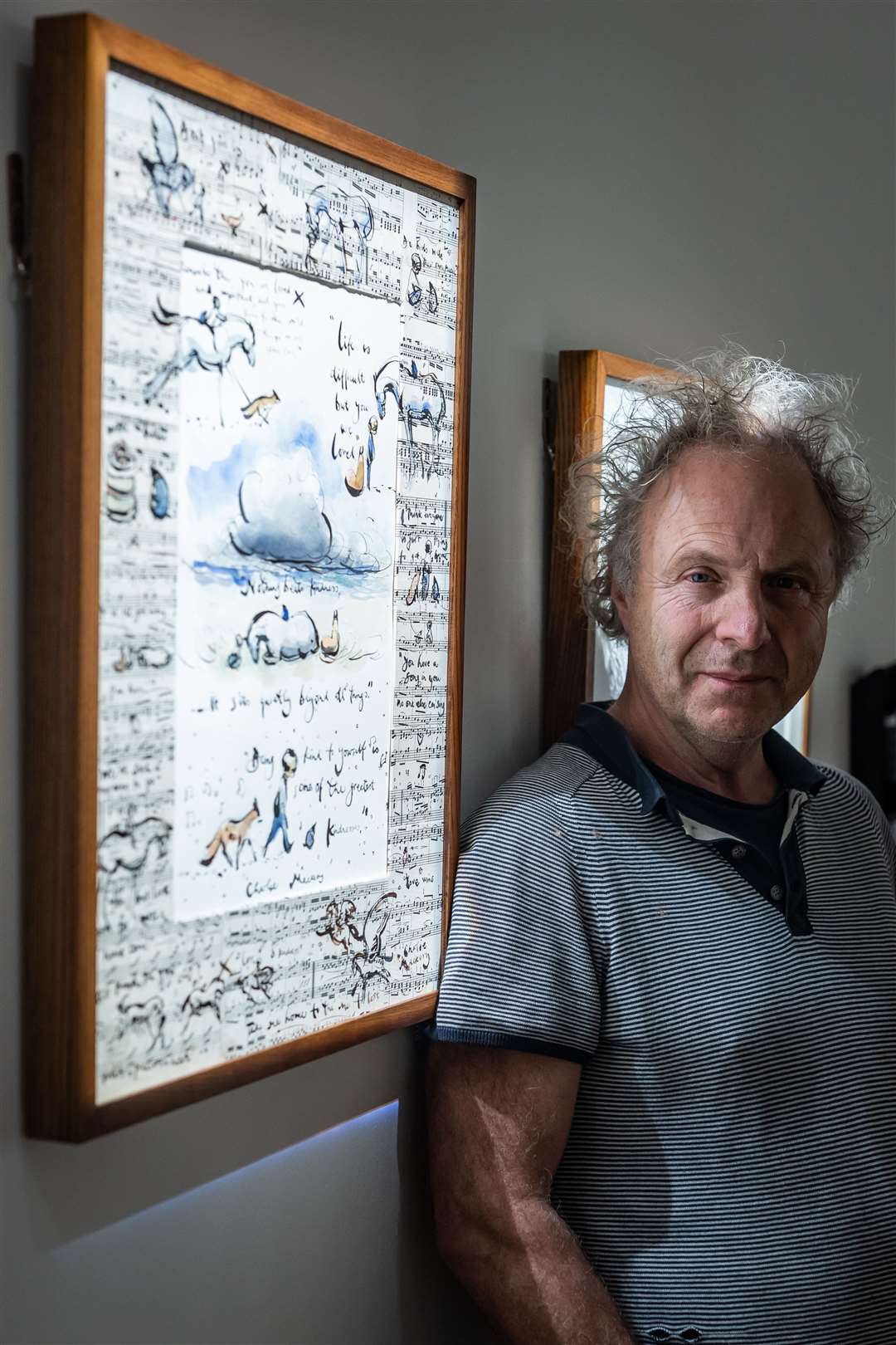 Author and illustrator Charlie Mackesy next to his latest exhibition (Aaron Chown/PA)