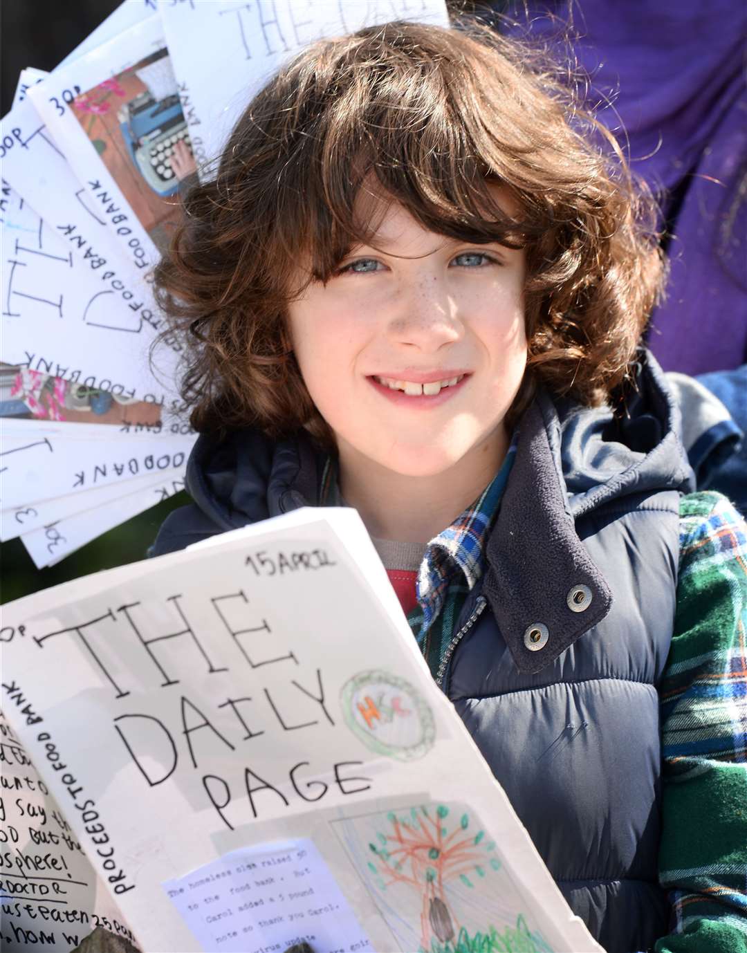 Ewan Karim (9) with copies of the newsaper he is producing every day. Picture: Gary Anthony