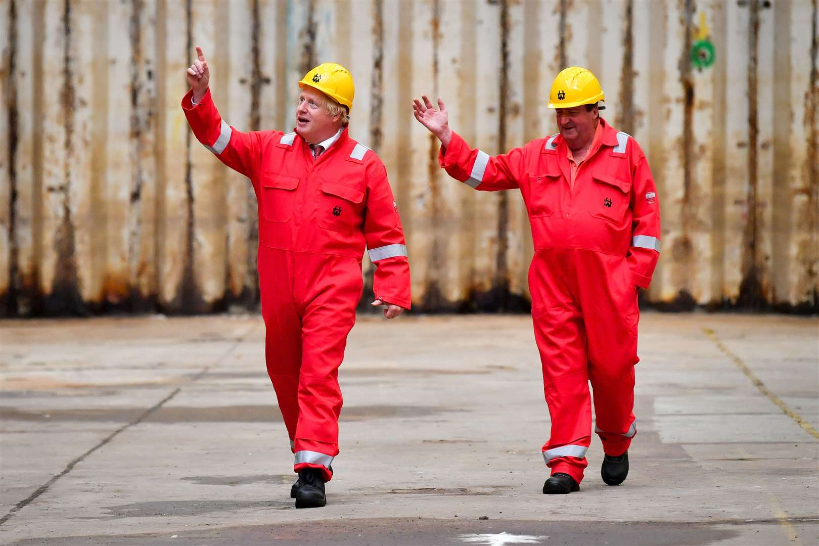 Prime Minister Boris Johnson walks in the dry dock with caretaker Clifford Edwards during his visit to Appledore Shipyard (Ben Birchall/PA)