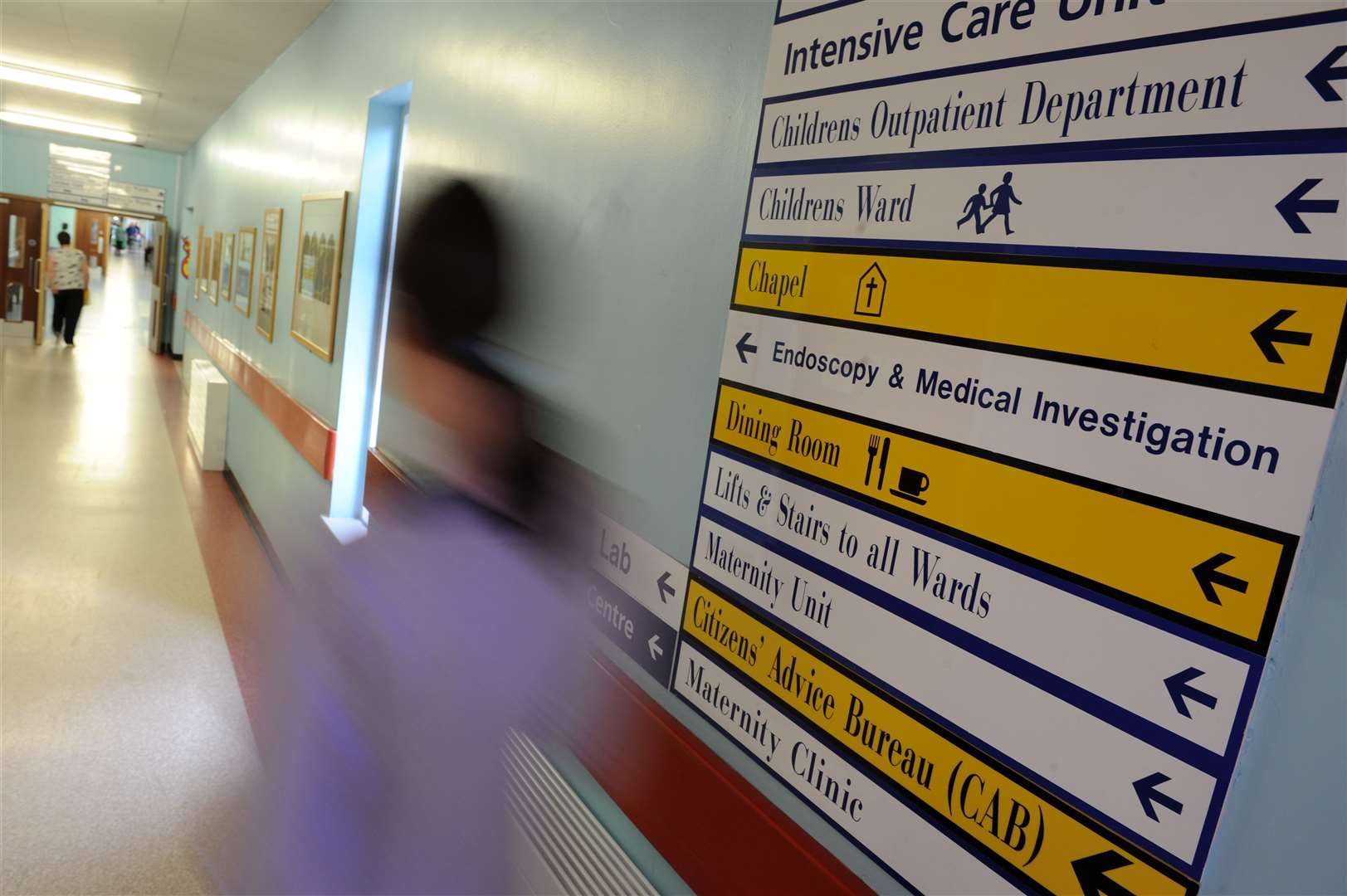 Multiple signs on a corridor at Raigmore Hospital.
