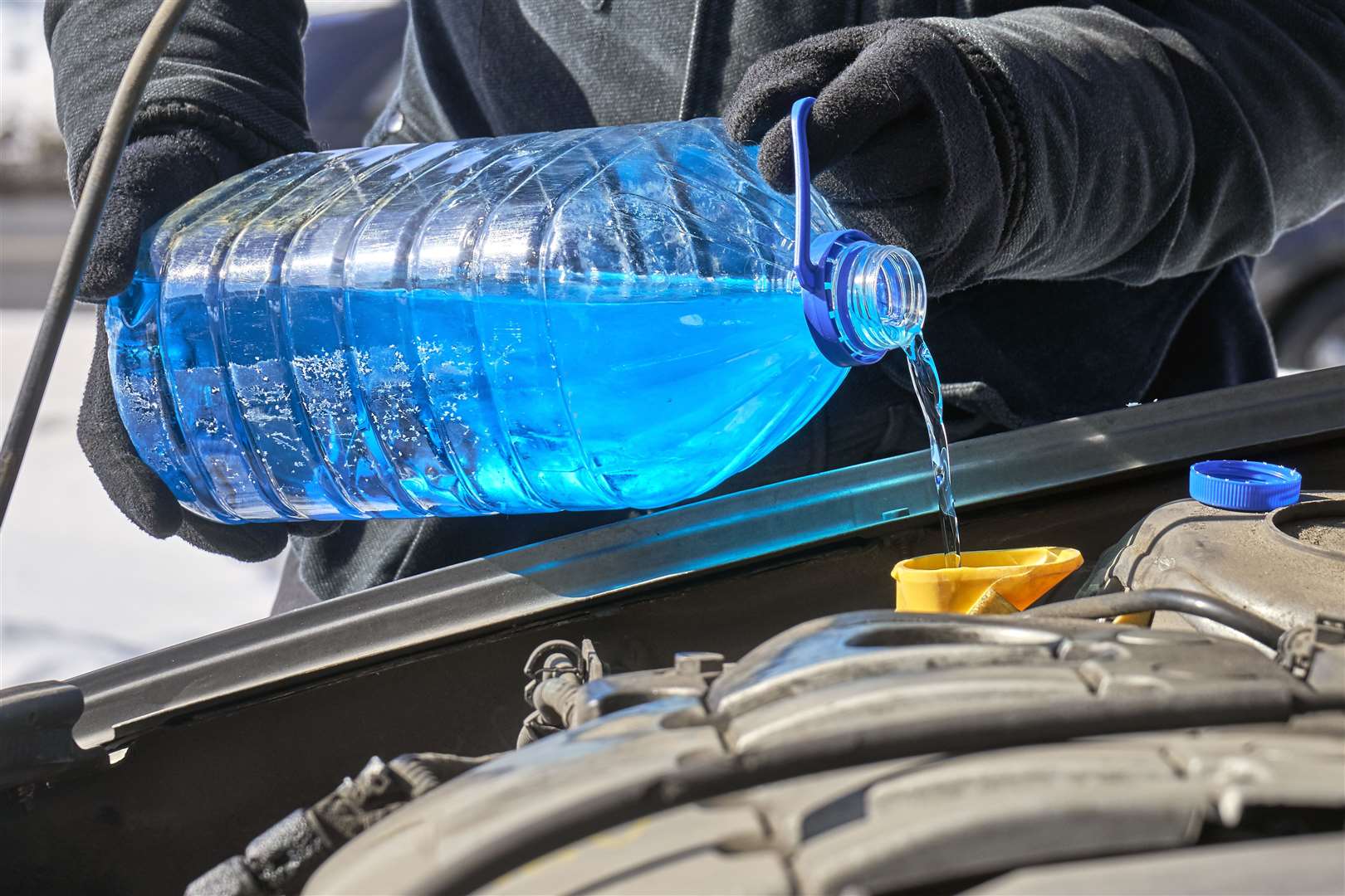 Antifreeze being poured into a car engine