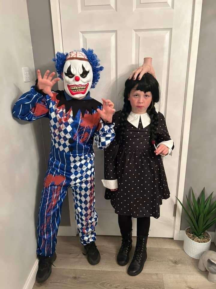 Caeden dressed as a clown and Emmy dressed as Wednesday Adams
