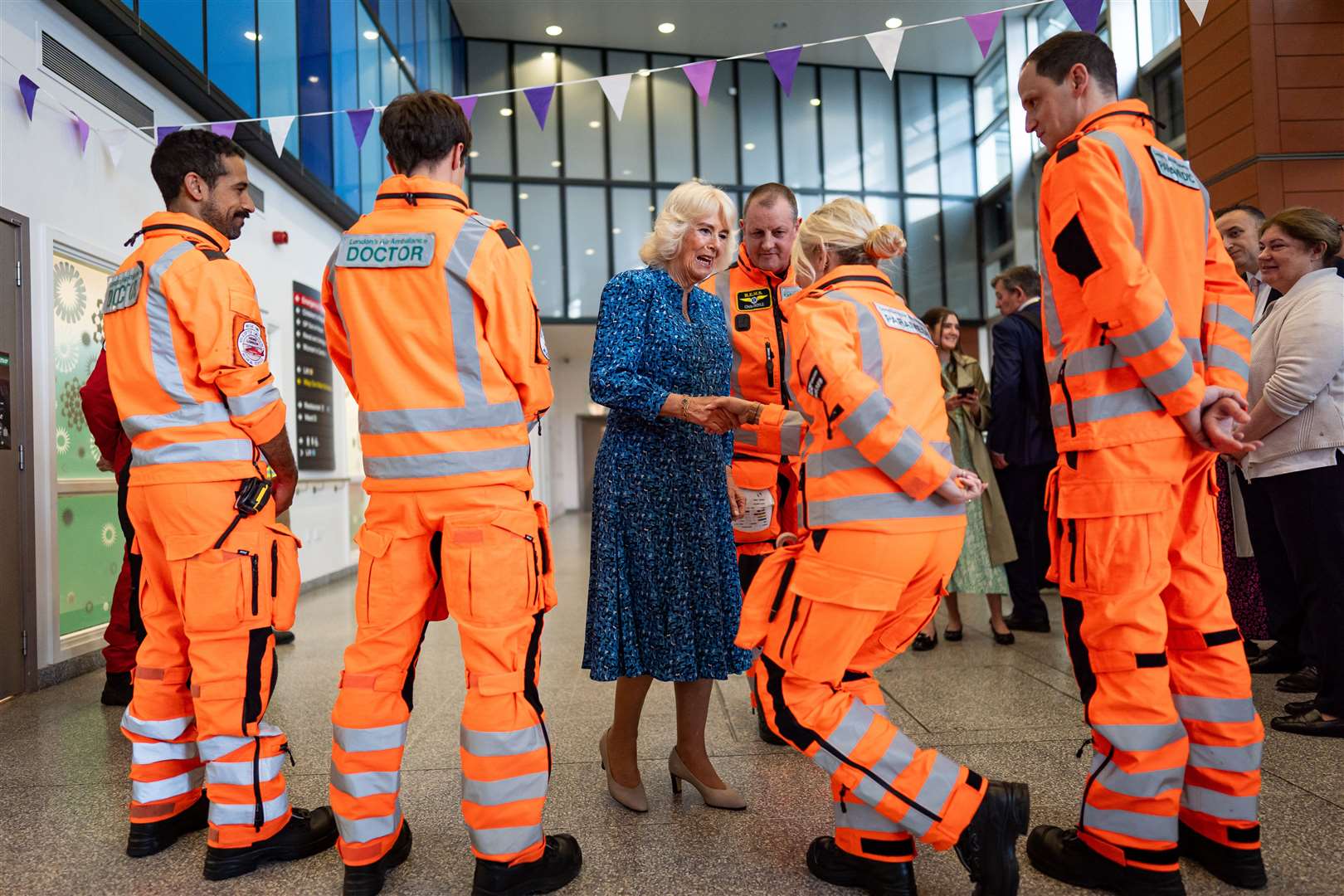 The Queen meets members of the air ambulance service during a visit to the Royal London Hospital (Aaron Chown/PA)