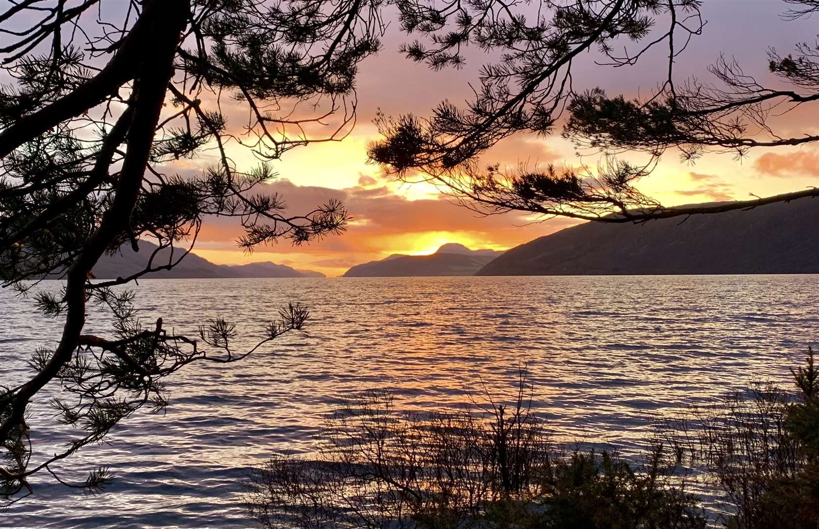 The sun sets behind Meall Fuar-mhonaidh on Loch Ness – taken at Dores by Richard Castro, Inverness Men’s Shed.