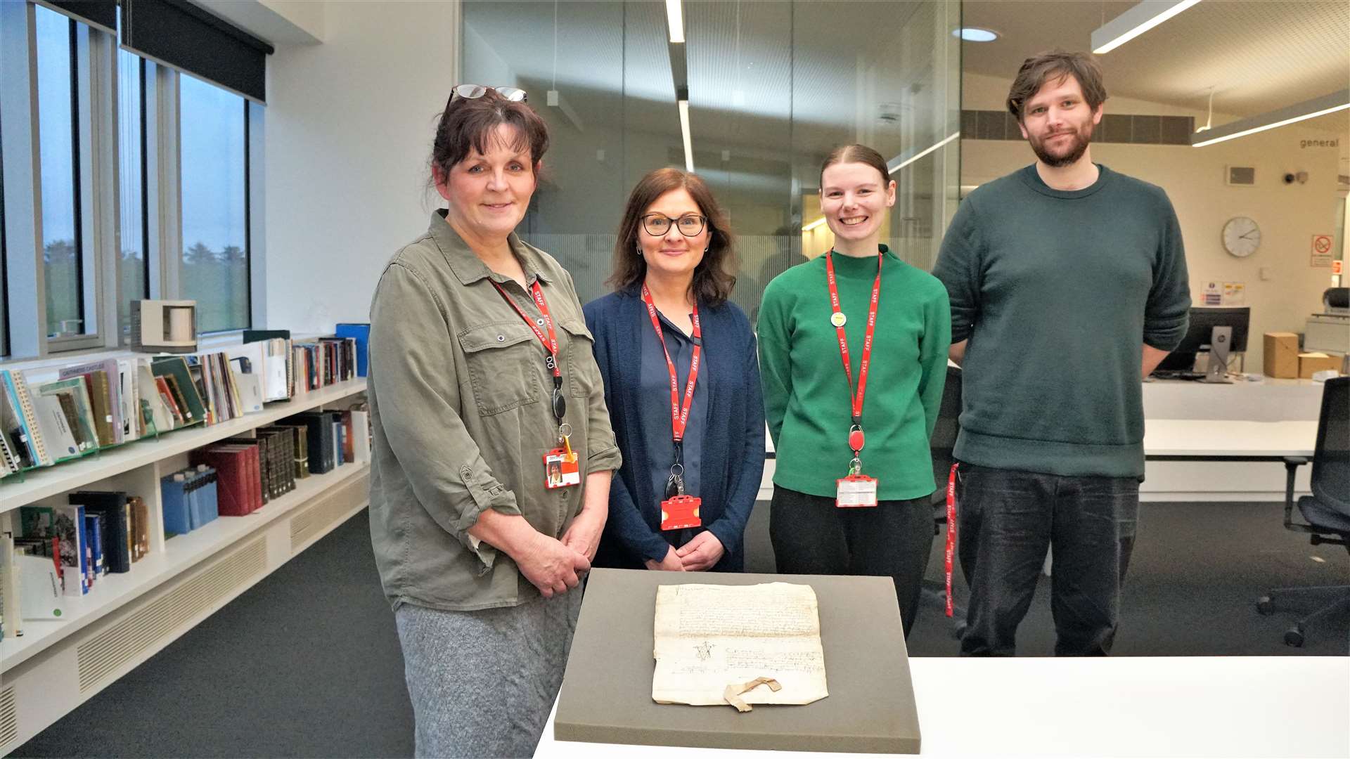 Caithness Archives staff from left, Ann Mackay, Valerie Amin, Jennifer Ross and Jamie McCaffrey with the 15th century document, the second oldest in their collection related to Caithness. Picture: DGS