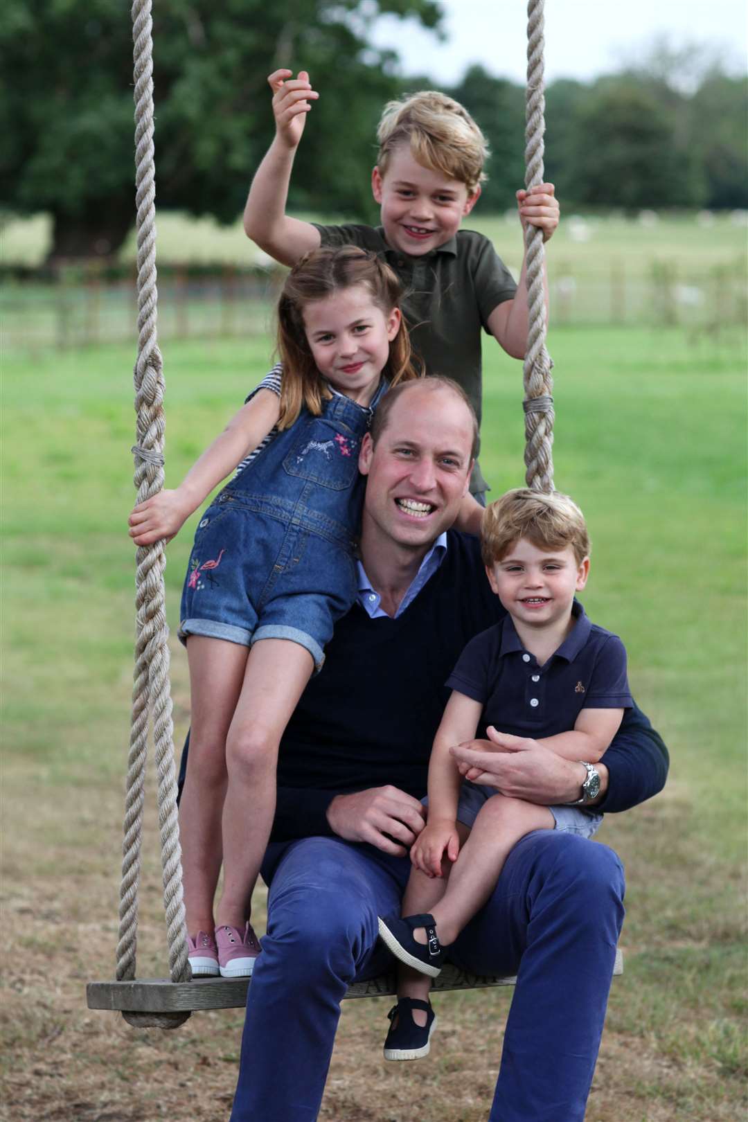 On a swing in their Norfolk garden (Duchess of Cambridge/Kensington Palace/PA)