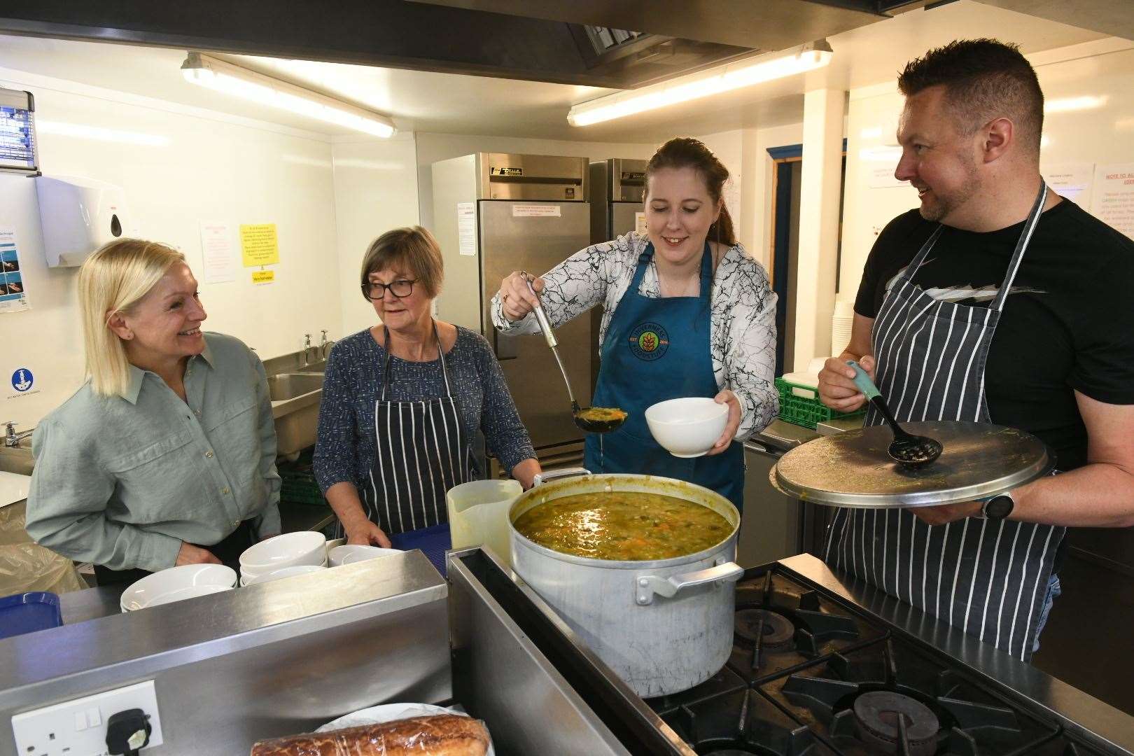 Equalities Minister Emma Roddick helps serve up lunch at Inverness Foodstuff.