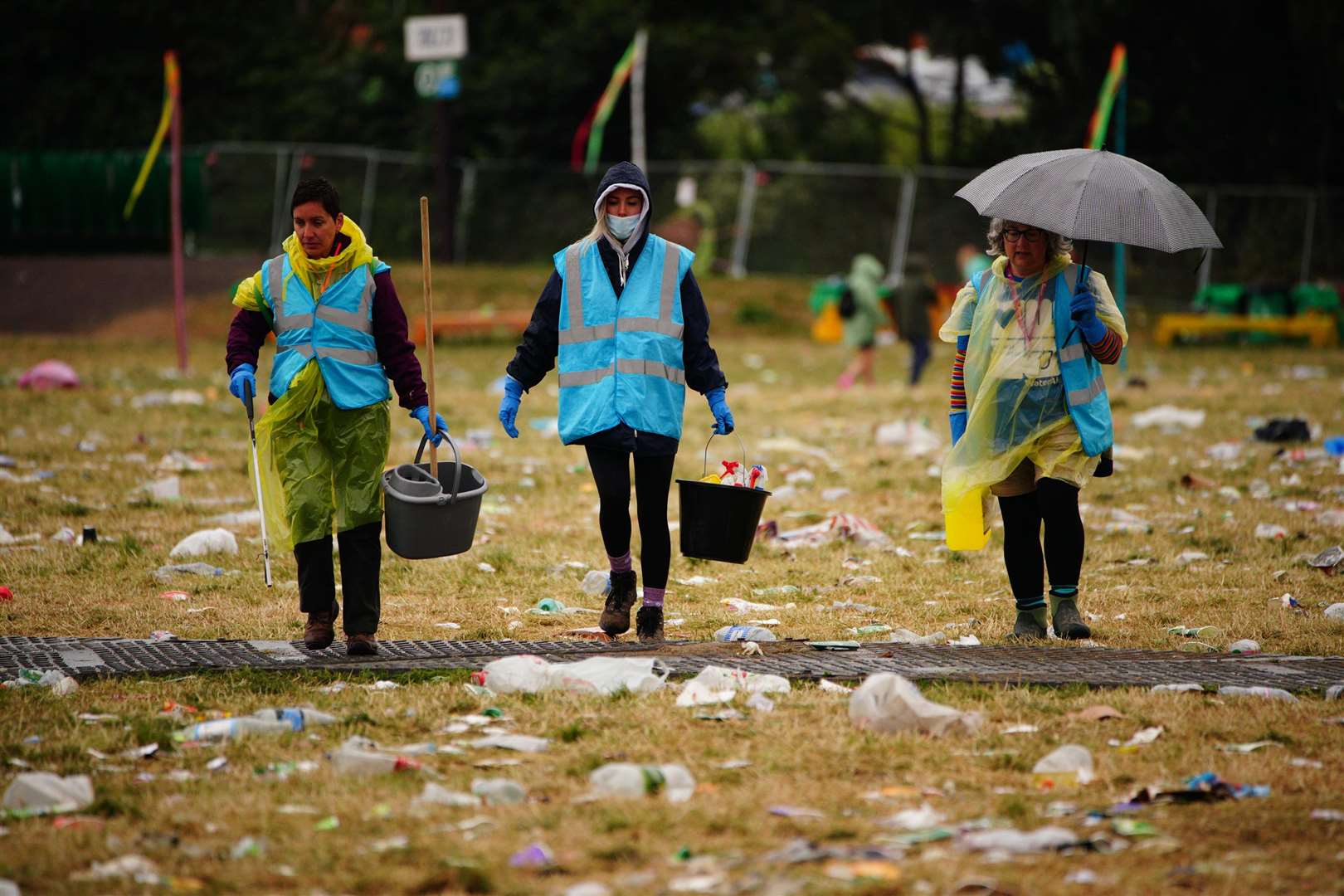 Litter-pickers work to clear the mess (Ben Birchall/PA)