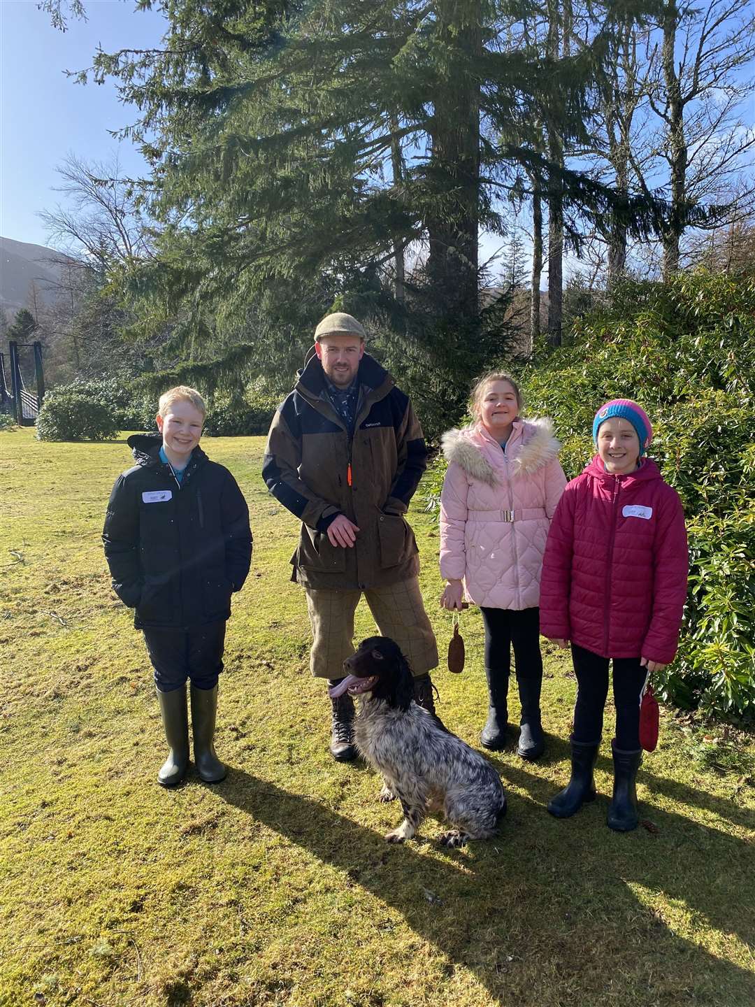 Dunmaglass Gamekeeper Raymond Robertson with his dog Moss and some of the children following the working dog demonstration