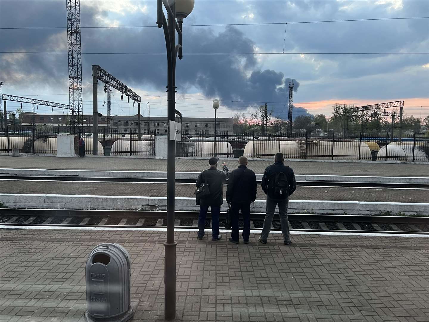 Passengers observe the smoke rising from a rocket attack in Lviv in Ukraine.