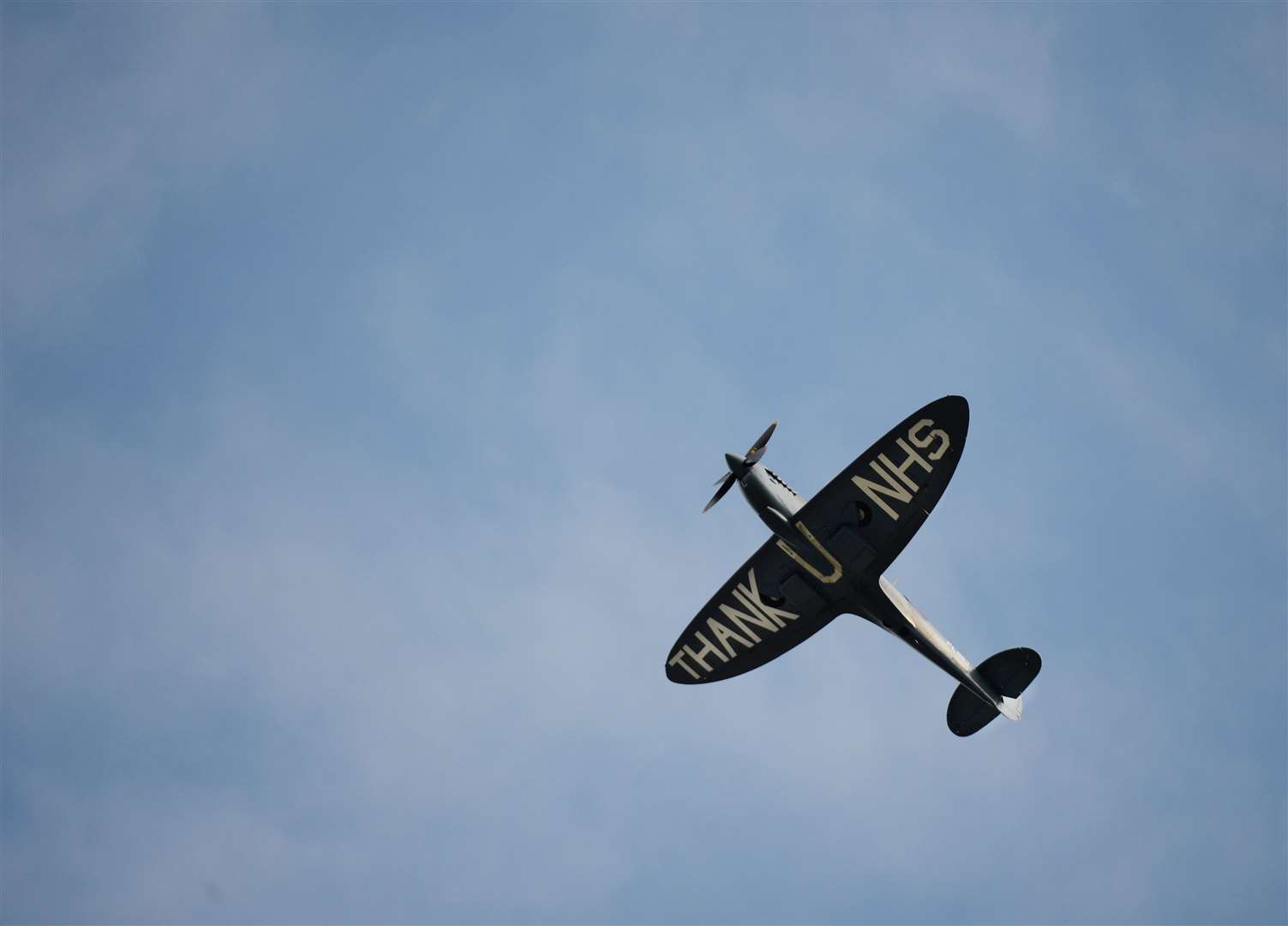 Spitfire flys over Raigmore Hospital with Thank You message for NHS staff, staff and visitors come out to see gesture. Picture: Gary Anthony.