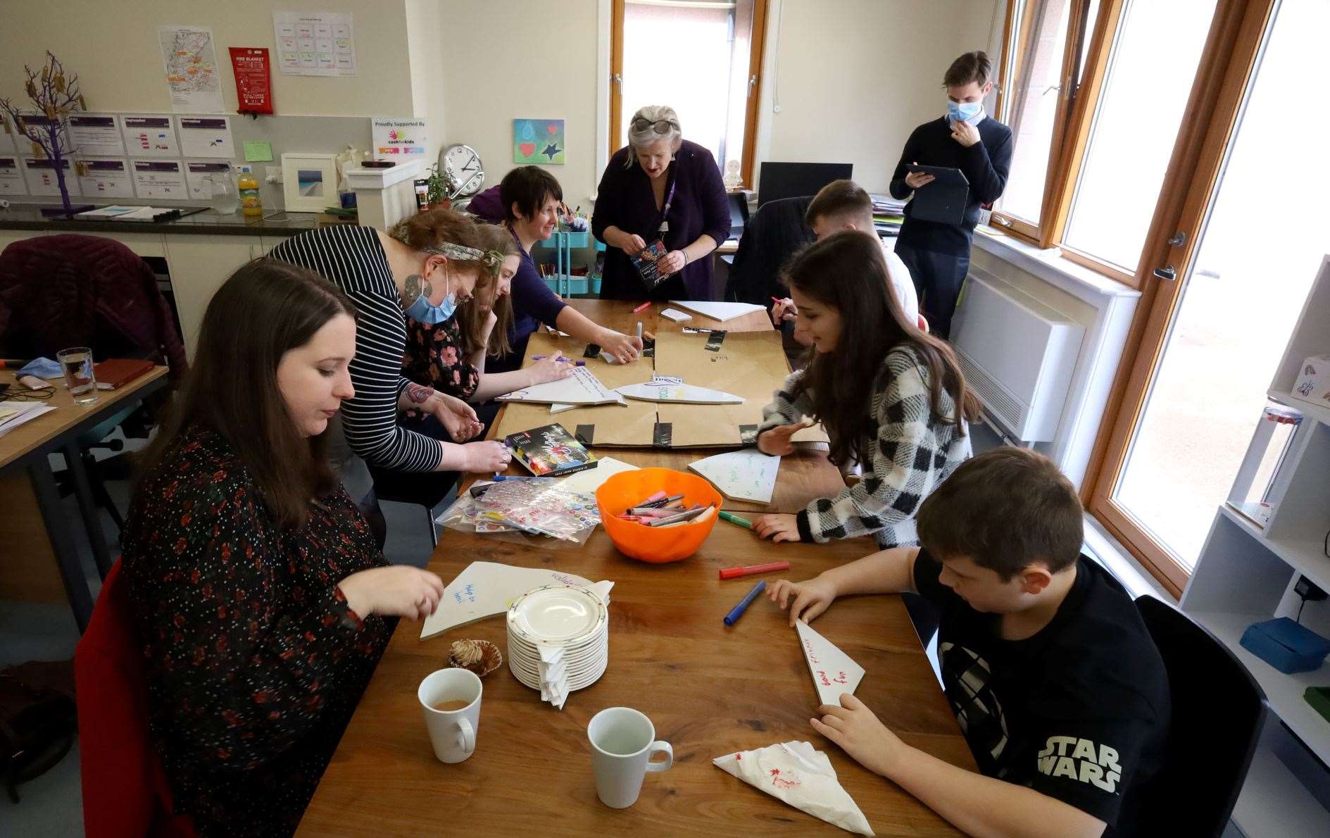 Everyone decorating their cracked piece of porcelain. Picture: James Mackenzie