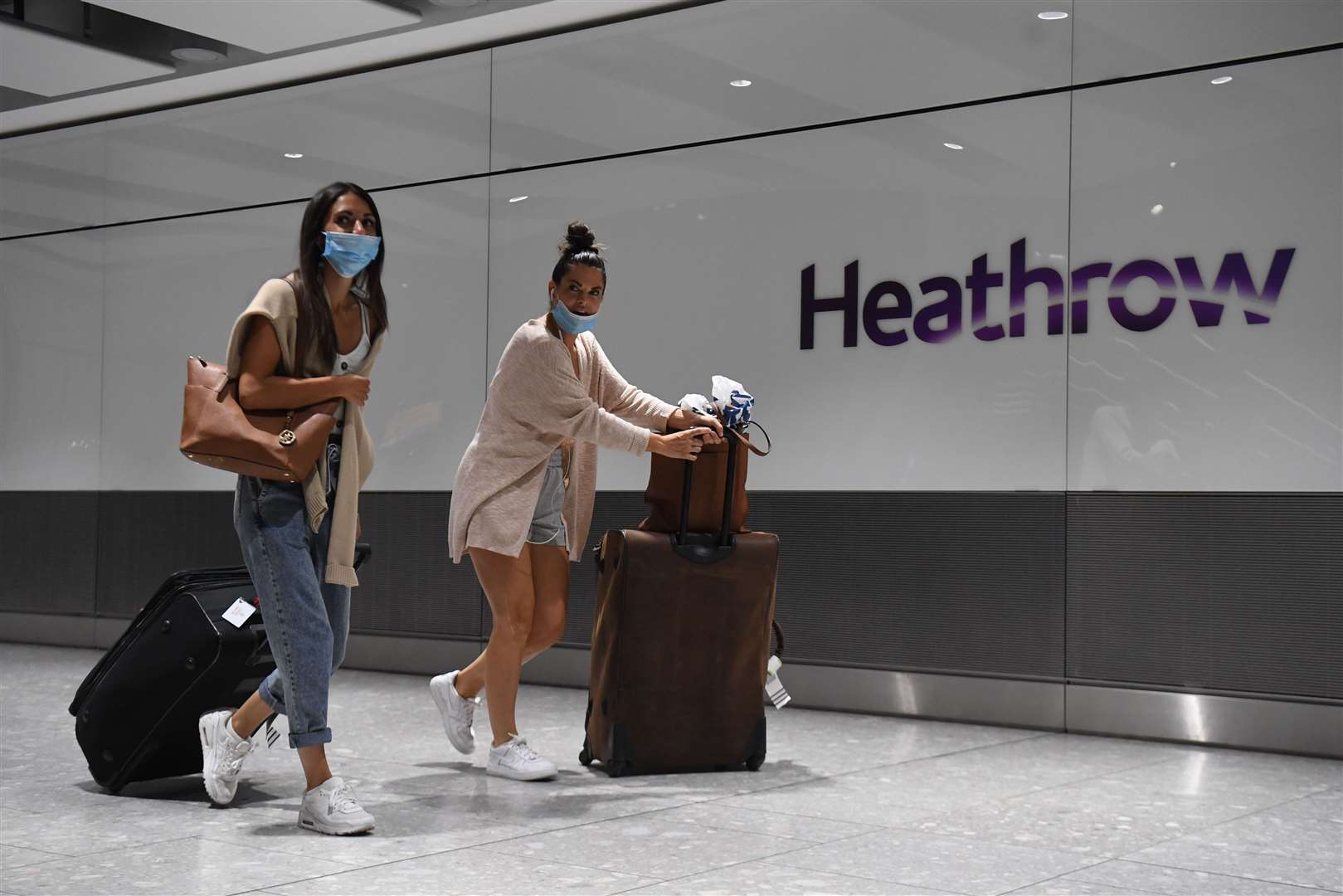 Passengers wearing face masks as they arrive at Heathrow Airport after a flight from Dubrovnik, Croatia (Kirsty O’Connor/PA)