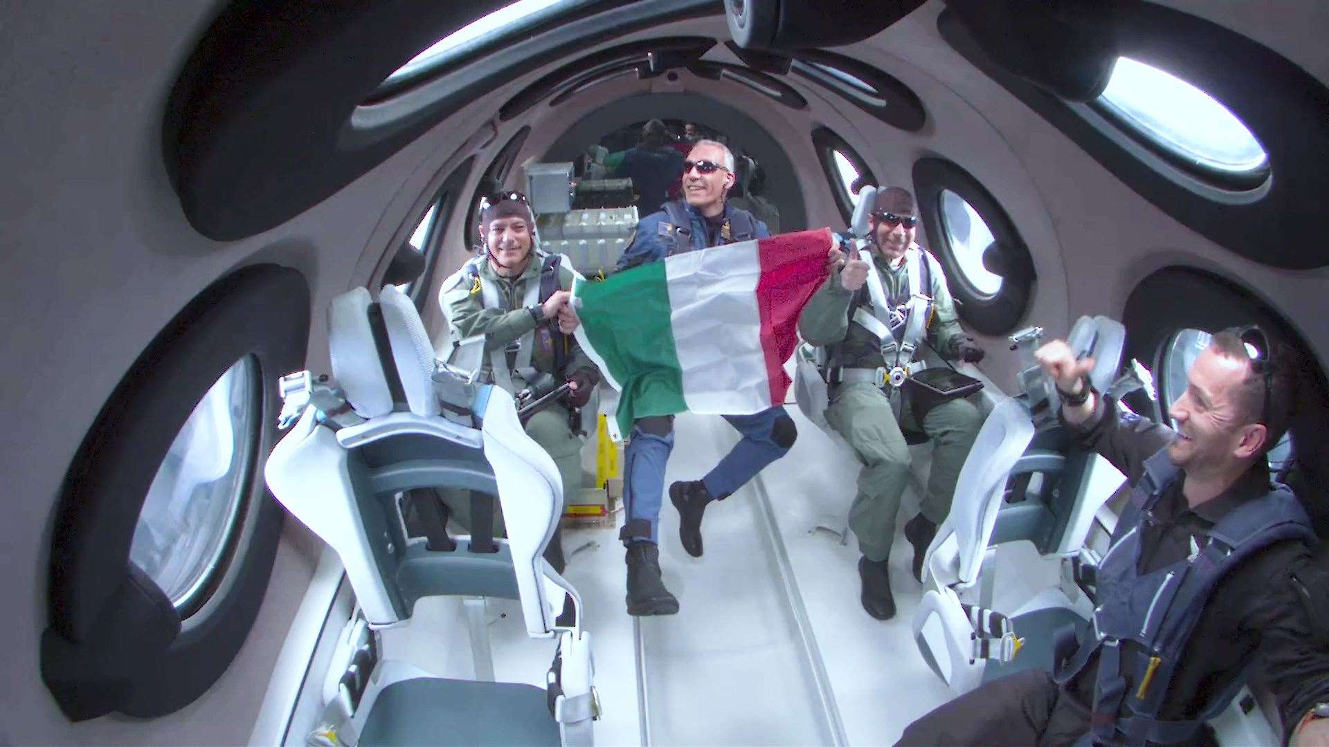 Italian Air Force Colonel Walter Villadei holding up an Italian flag as he and other Italian researchers experienced a few moments of weightlessness (Virgin Galactic/PA)