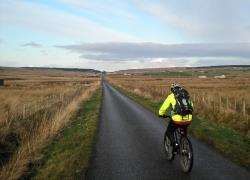 Peter Evans on the straight road back to the forest at Camster