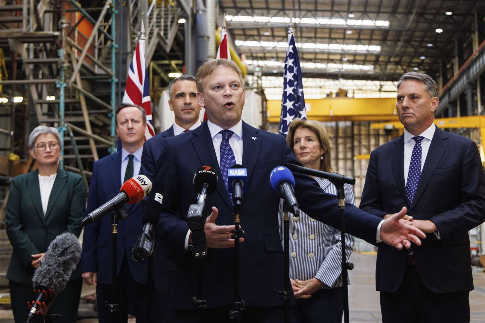 Defence Secretary Grant Shapps speaks to the media as Premier of South Australia Peter Malinauskas, third left, Australian Minister for Foreign Affairs Penny Wong, left, Deputy Prime Minister of Australia Richard Marles, right, Foreign Secretary David Cameron and United States Ambassador to Australia Caroline Kennedy, second right, listen during a visit to the Osborne Naval Shipyard in Adelaide (Matt Turner/AAP/AP)