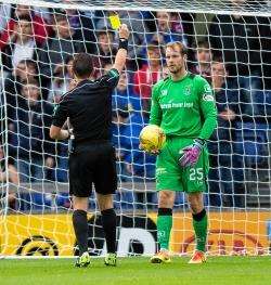 Owain Fon Williams is booked by referee Andrew Dallas. Picture: Ken Macpherson.