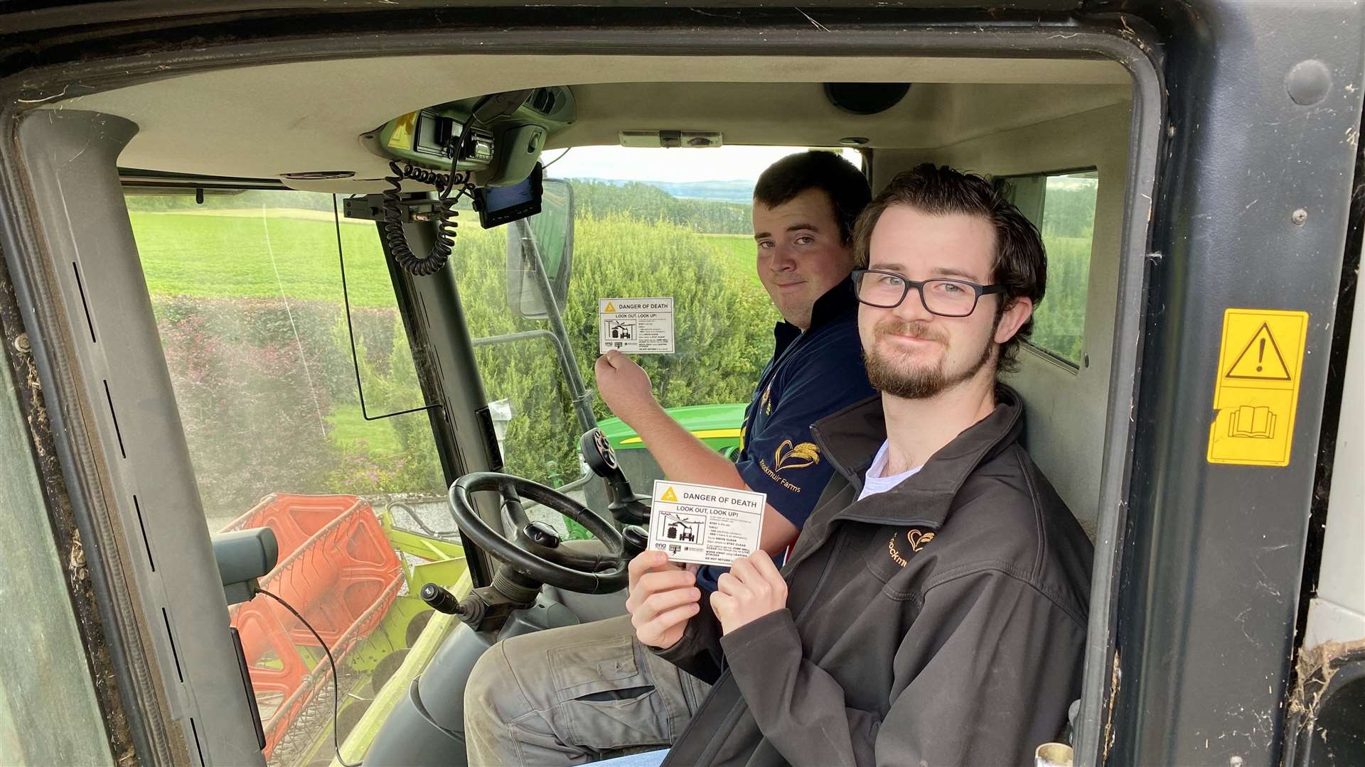 Ewan (in blue) and Ross with the SSEN farm safety stickers.