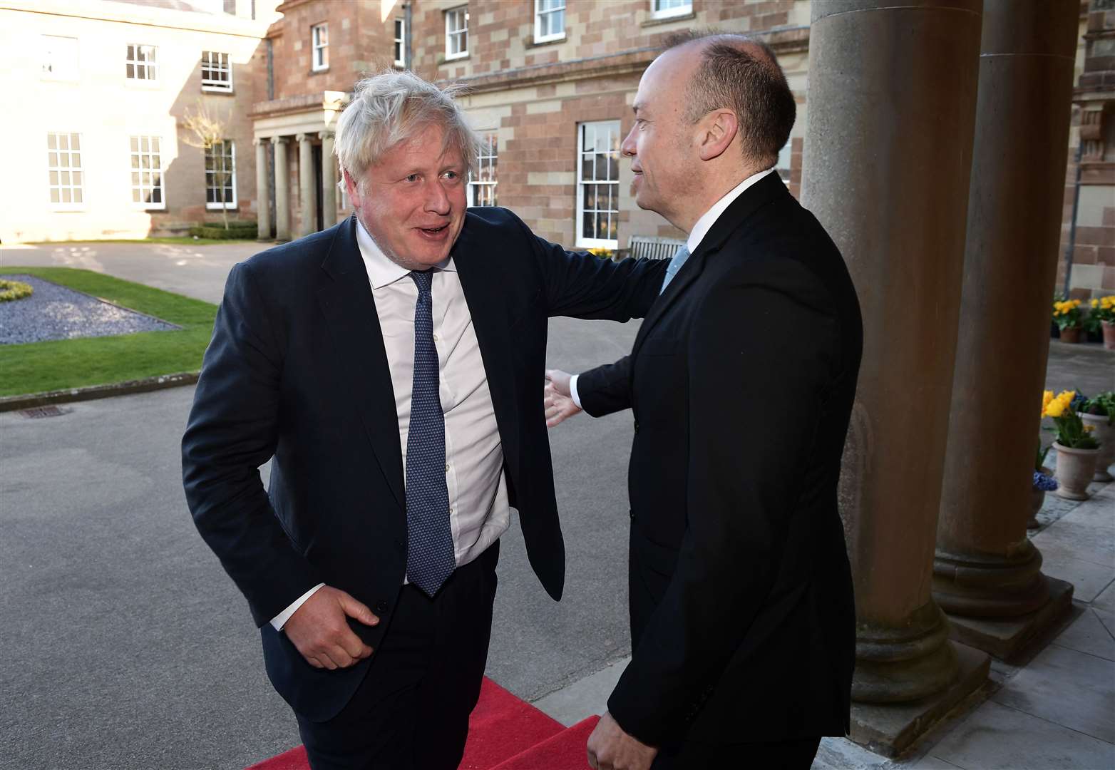 Former prime minister Boris Johnson (left) greets Northern Ireland Secretary Chris Heaton-Harris as they arrive for a gala dinner at Hillsborough Castle, Co Down (Charles McQuillan/PA)