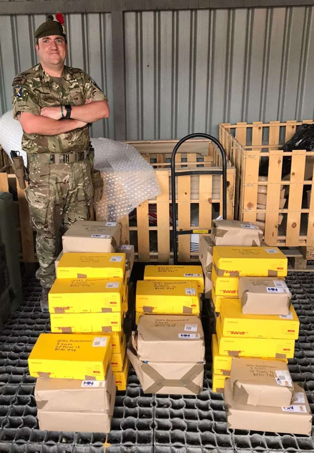 Laura McCarthy's husband with the first batch of Treats for Troops following their arrival in Afghanistan.