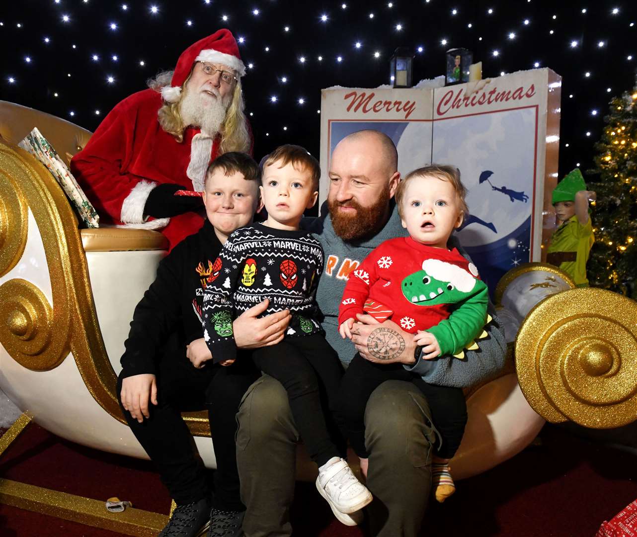 Riley, Rory and Reece Leat and their dad getting a photo with Santa. Picture: James Mackenzie