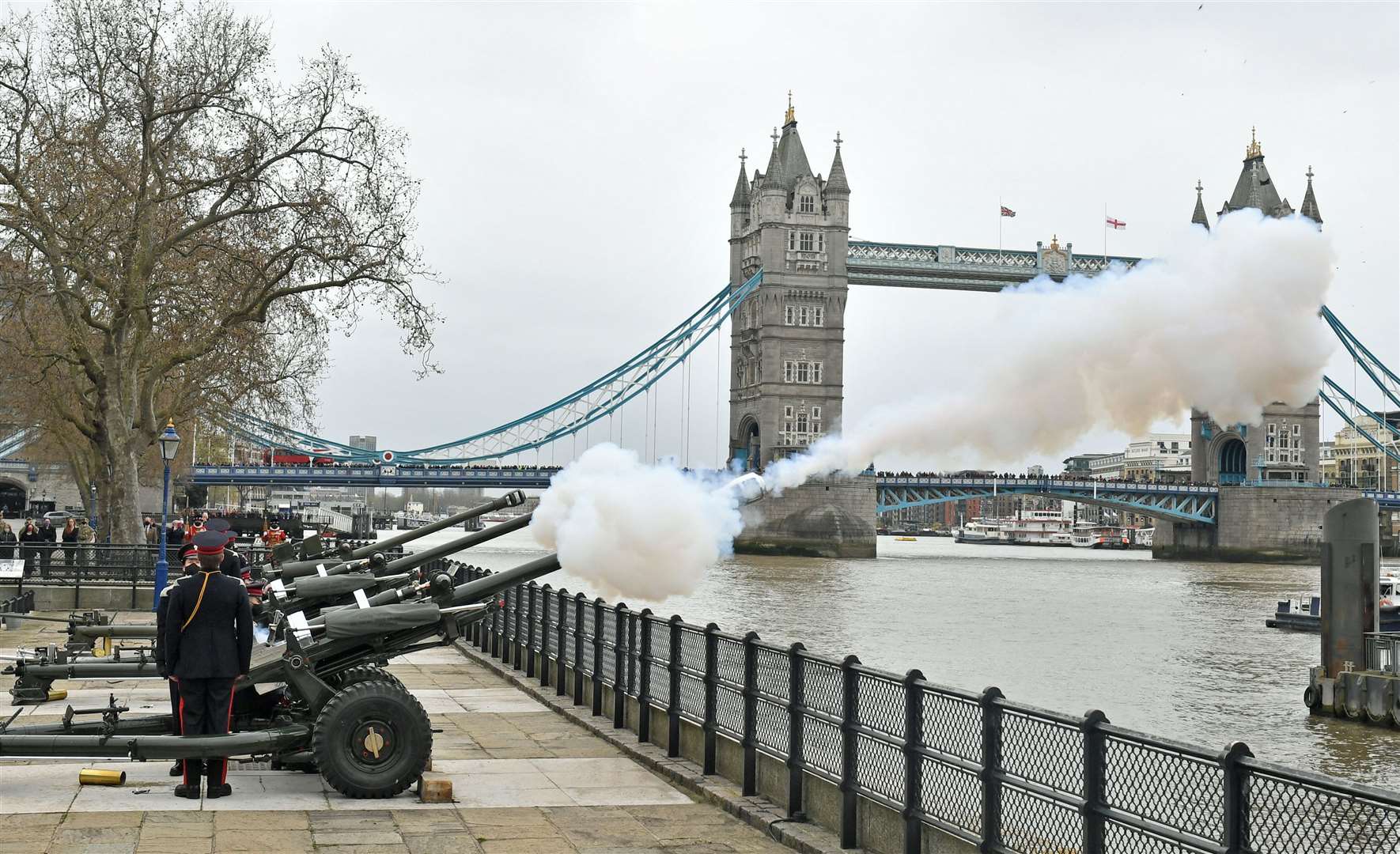 Members of the Honourable Artillery Company begin the 41-round gun salute from the wharf at the Tower of London (Dominic Lipinski/PA)