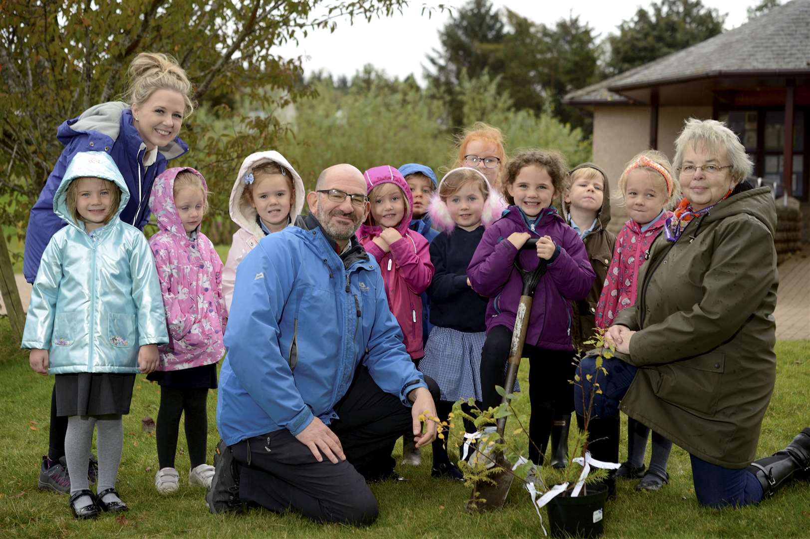 Cllr Trish Robertson and Grant Stuart, of Christie-Elite Nurseries, join Croy Primary School pupils to help plant trees.