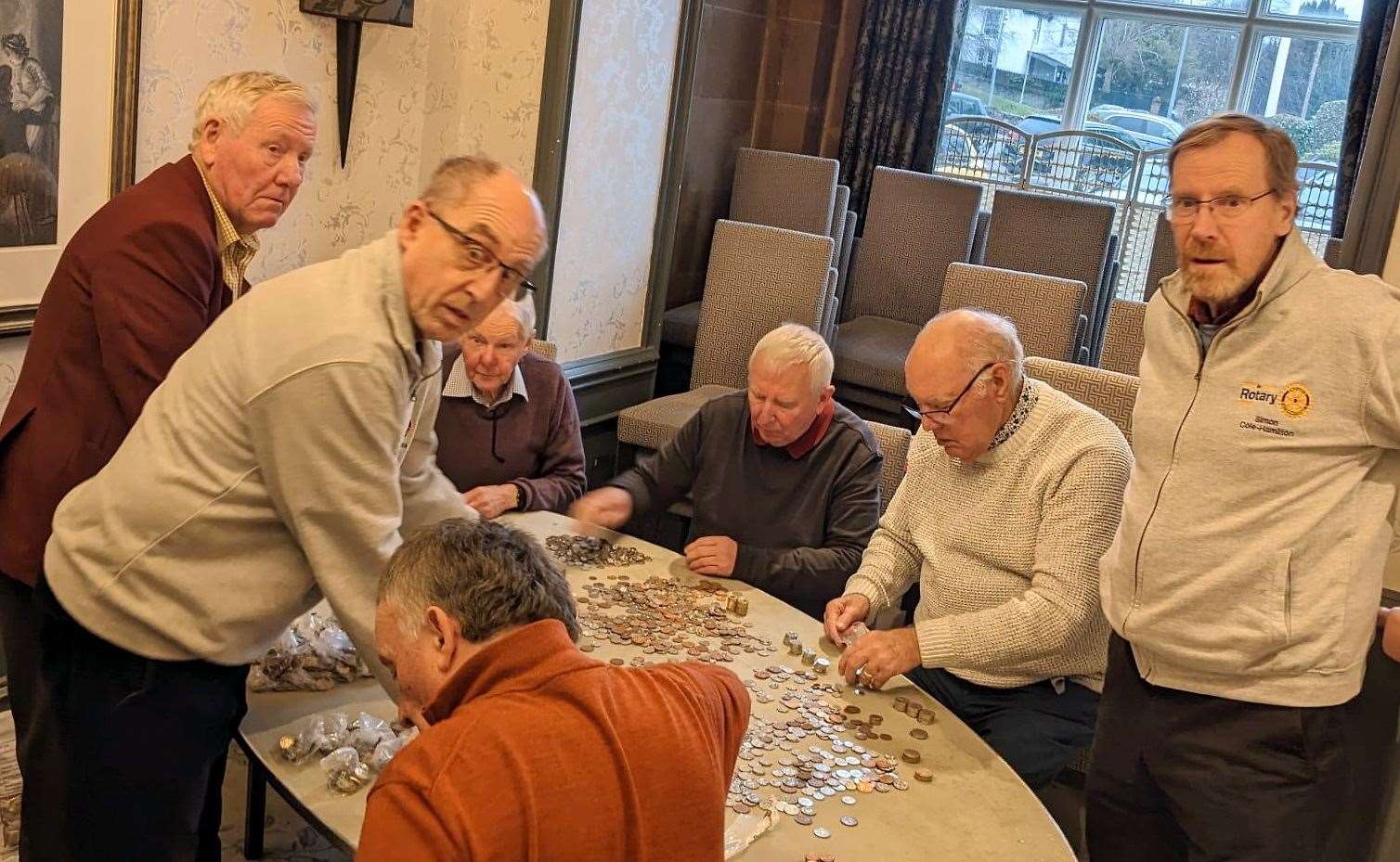 Rotary members counting donations.