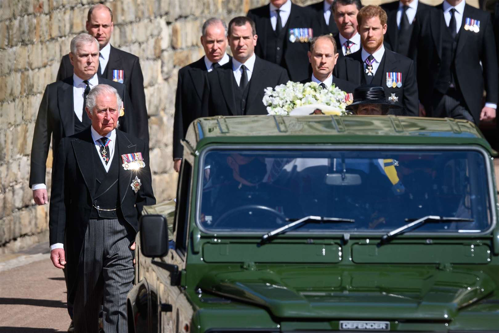The Duke of Sussex (far right) following the Land Rover Defender carrying the coffin of the Duke of Edinburgh in April 2021 (Leon Neal/PA)