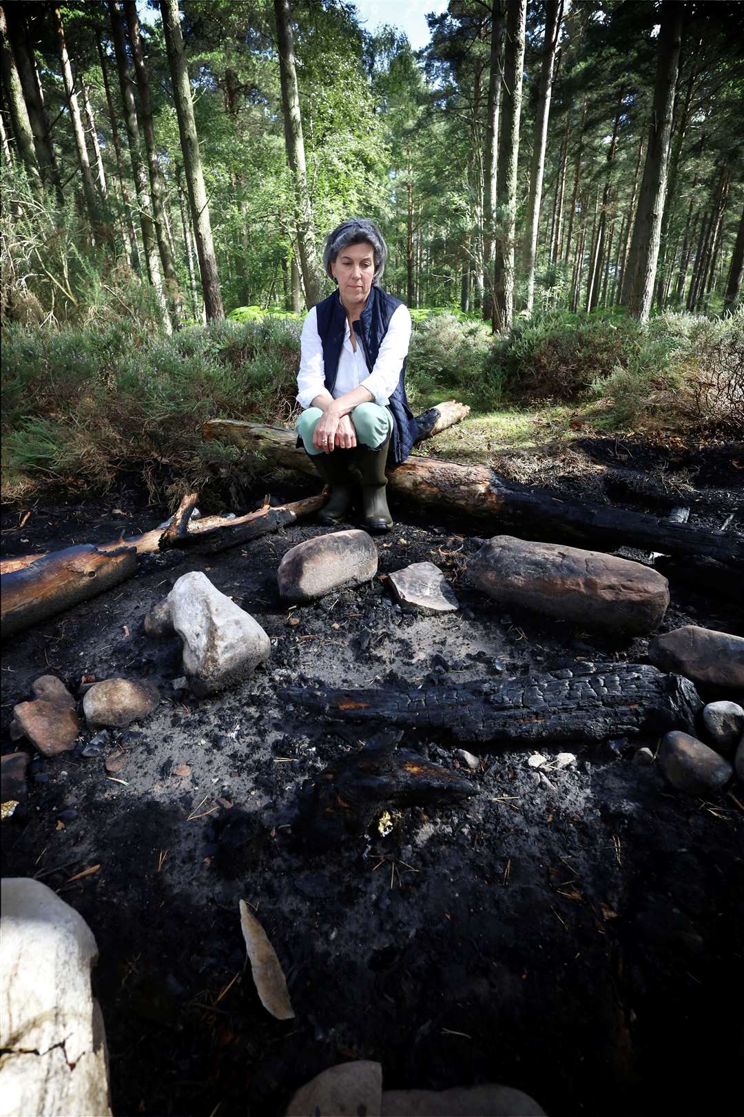 Lizzie Rose sat next to the ashes of the fire that almost got out of control. Picture: James Mackenzie.