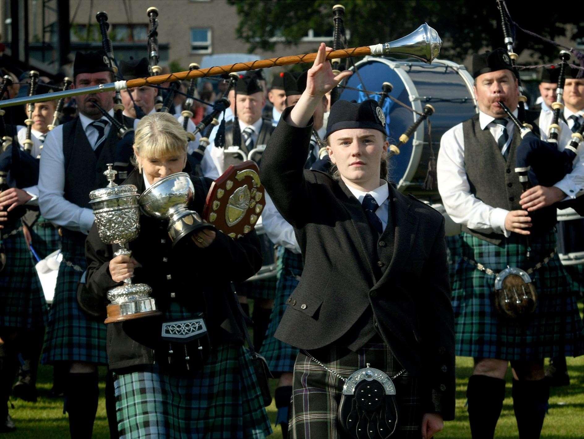 Inveraray drum major leading the way with the trophies following behind. Picture: James Mackenzie.