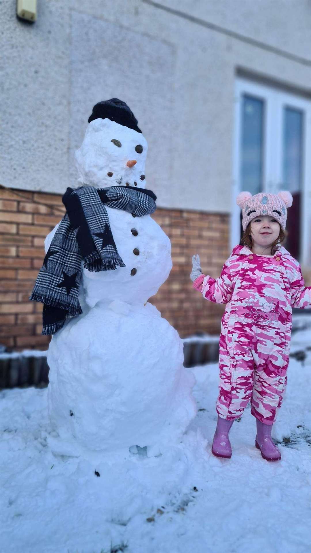 Billy Corbett took this shot of his two-year-old granddaughter, Caelin Corbett, from Evanton alongside her first ever snowman.