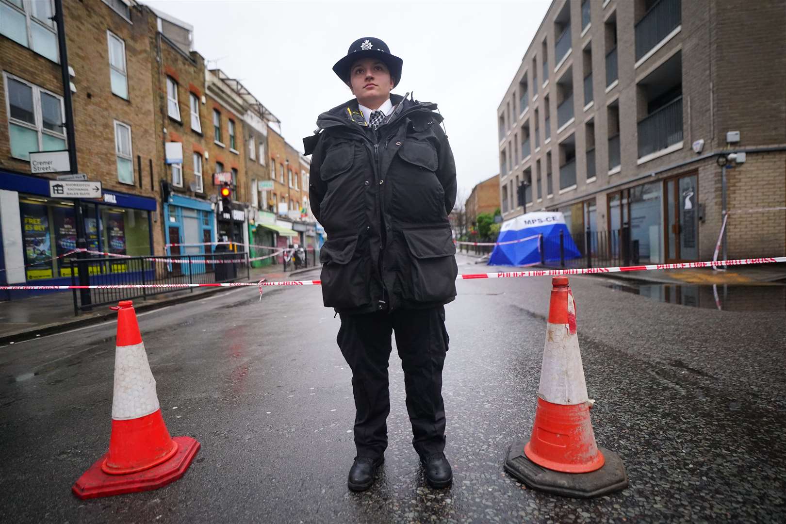 A police officer in Shoreditch, east London, near the scene (Victoria Jones/PA)