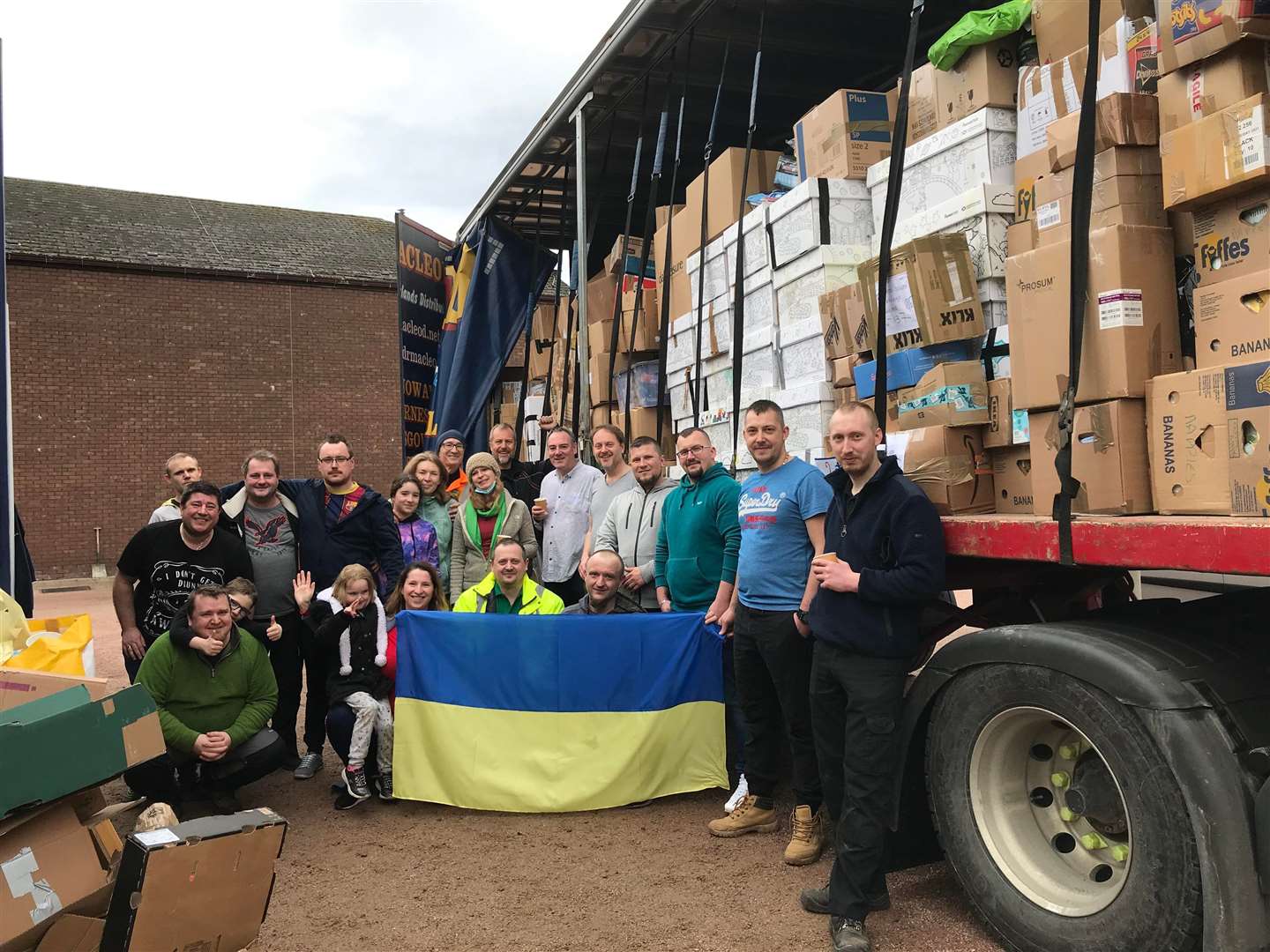 Iryna and daughter Anita (at front) with volunteers and a lorry of supplies.