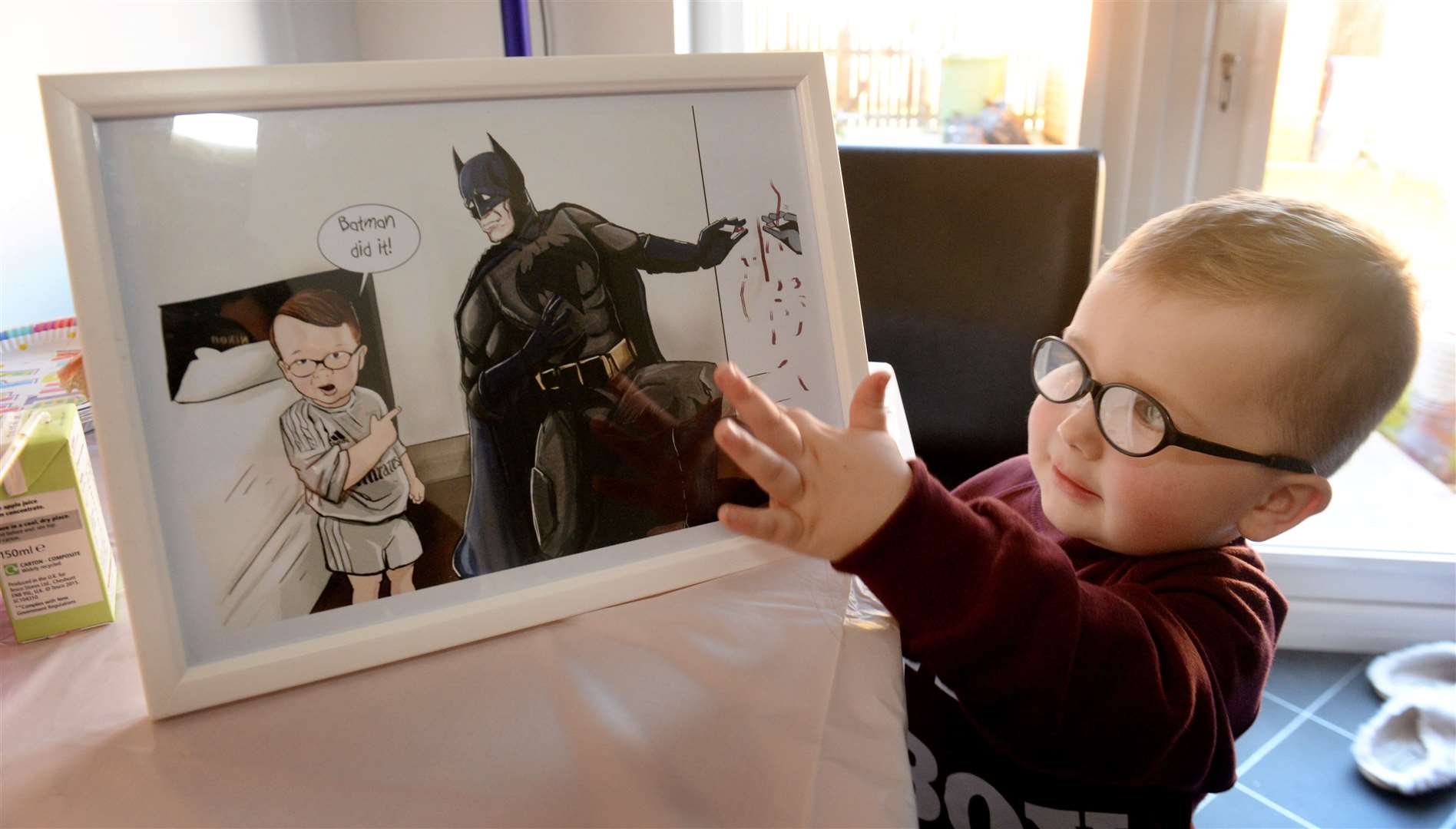 Noel Hopkins with the framed Batman illustration he received. Picture: Gair Fraser.