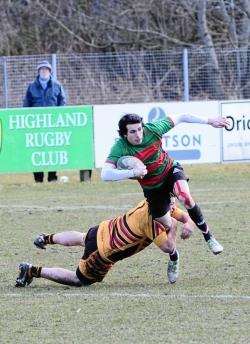 Highland's Richard Sim tries to evade a challenge from an Ellon player. Pic by Alison White.