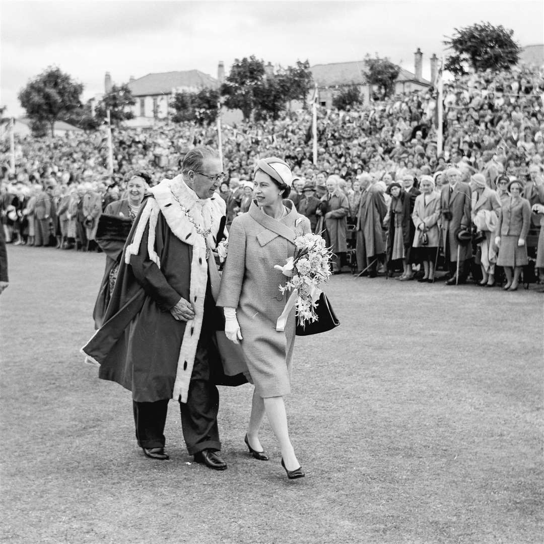 Escorted by Provost G Borwick, the Queen tour the youth organisations at the Links, Nairn. The Queen and The Duke of Edinburgh visit Nairn on Monday, August 14 1961. From the Northern Scot archive.