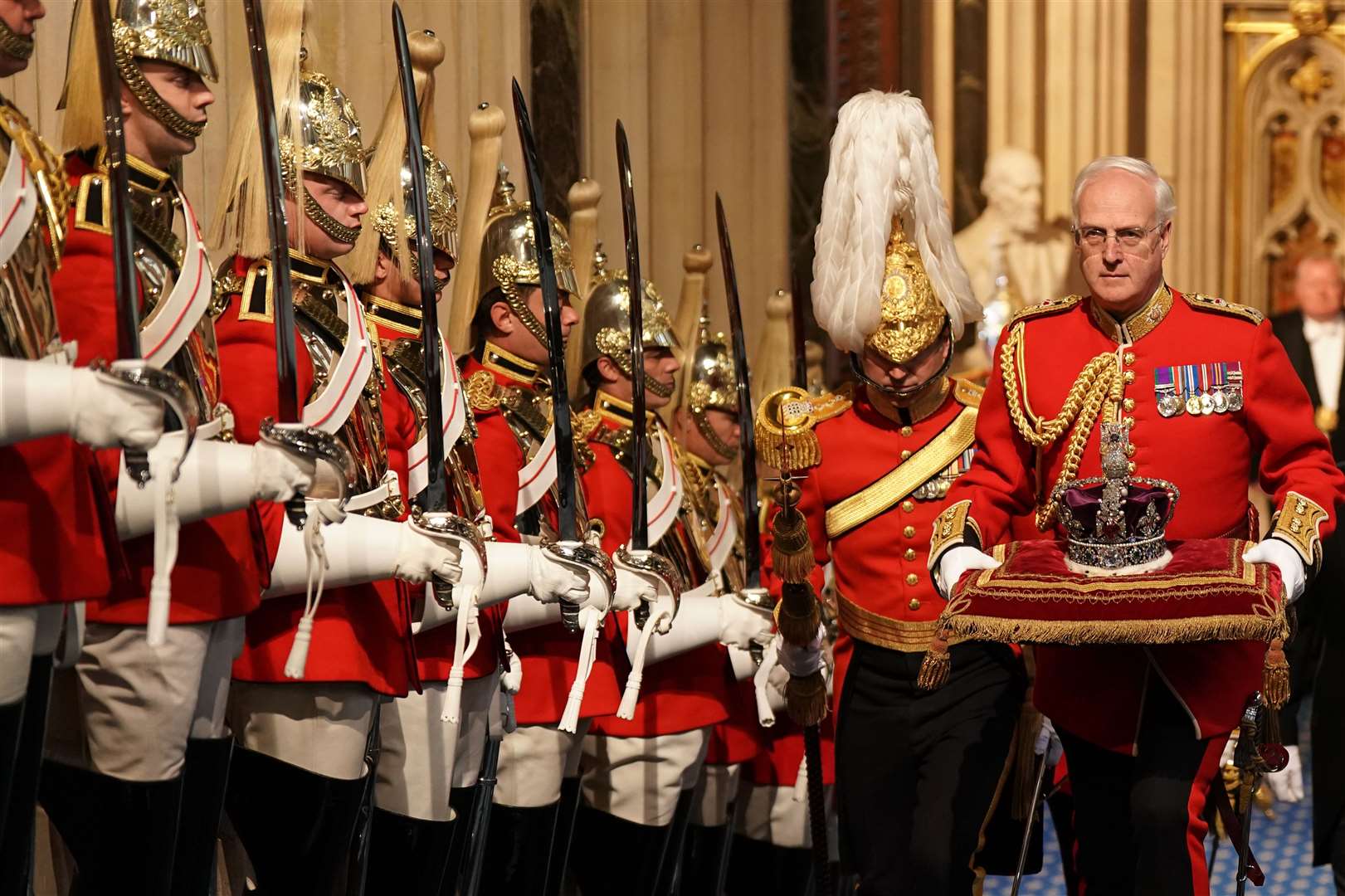 The Imperial State Crown is carried through the Norman Porch for the State Opening of Parliament in the House of Lords at the Palace of Westminster (Aaron Chown/PA)