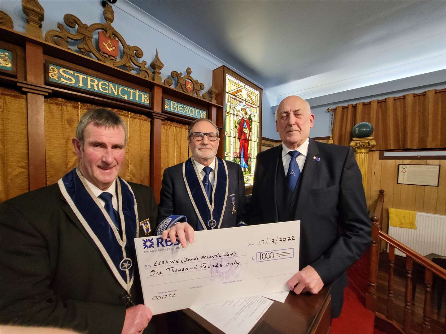 Lodge treasurer James Whyte (left) with RWM John I MacKay (centre) handing over the cheque to veteran John Baillie (right) at the Masonic Temple on Gordon Terrace, Inverness.