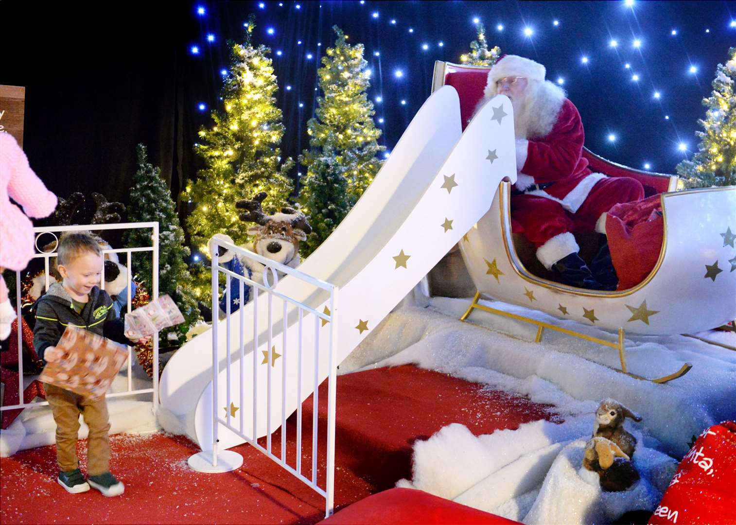 Logan Gordon collects his gifts at the bottom of the slide.