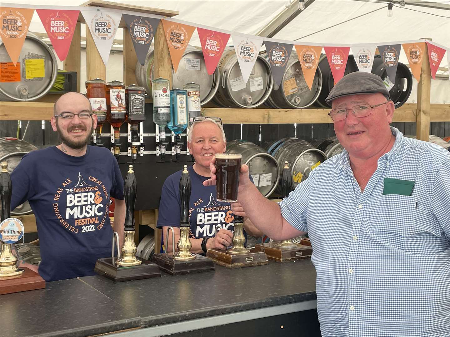Cheers from Martin, a visitor from Luton who enjoyed the first pint at the festival served by Ali Deans and Andrew Gardiner.