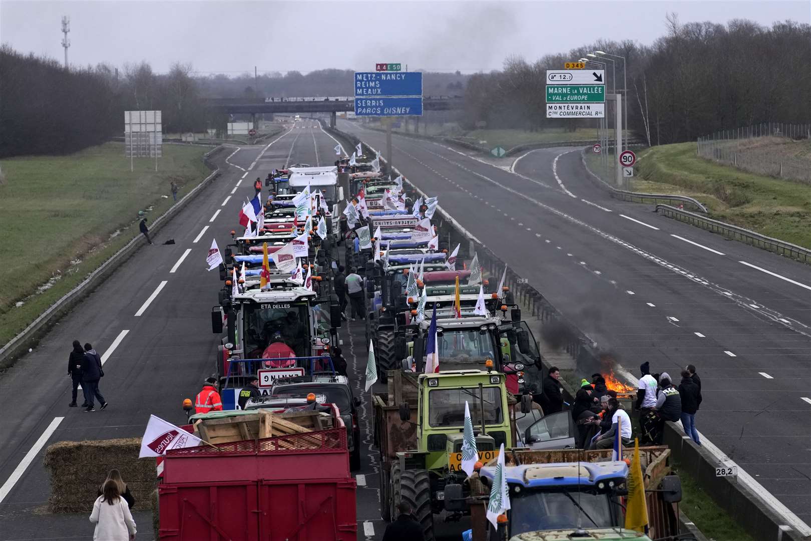 Farmers occupy the highway in Jossigny, east of Paris, with protesting farmers camped out at barricades around Paris (Christophe Ena/AP/PA)
