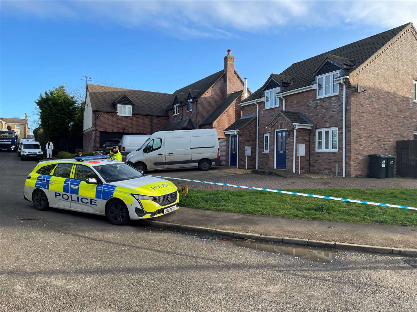 Police at the scene in The Row in Sutton, near Ely, Cambridgeshire, where police found the body of a 57-year-old man who had died from gunshot wounds (Sam Russell/PA)