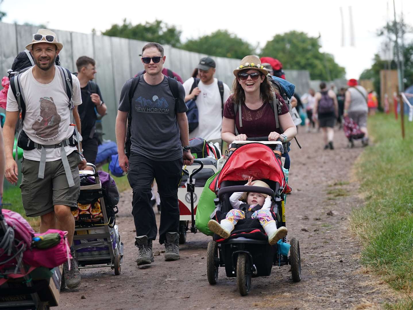 Heavy rain that fell intermittently on Worthy Farm throughout Wednesday did nothing to dampen the spirits to those arriving early for the festival (Yui Mok/PA)