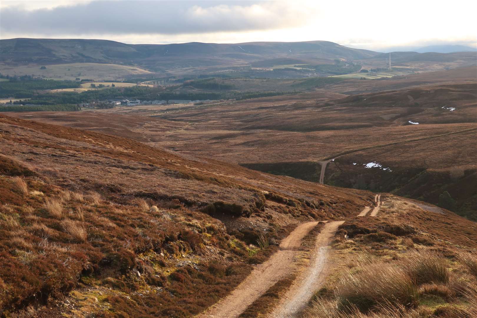 A steep descent from Carn Moraig gives a first view of Tomatin distillery down to the left.
