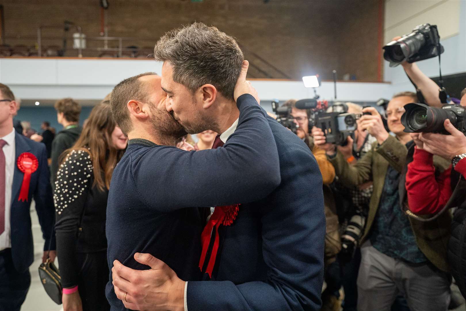 Labour candidate Damien Egan shares a kiss with his husband Yossi Felberbaum after being declared MP for Kingswood (Ben Birchall/PA Wire)
