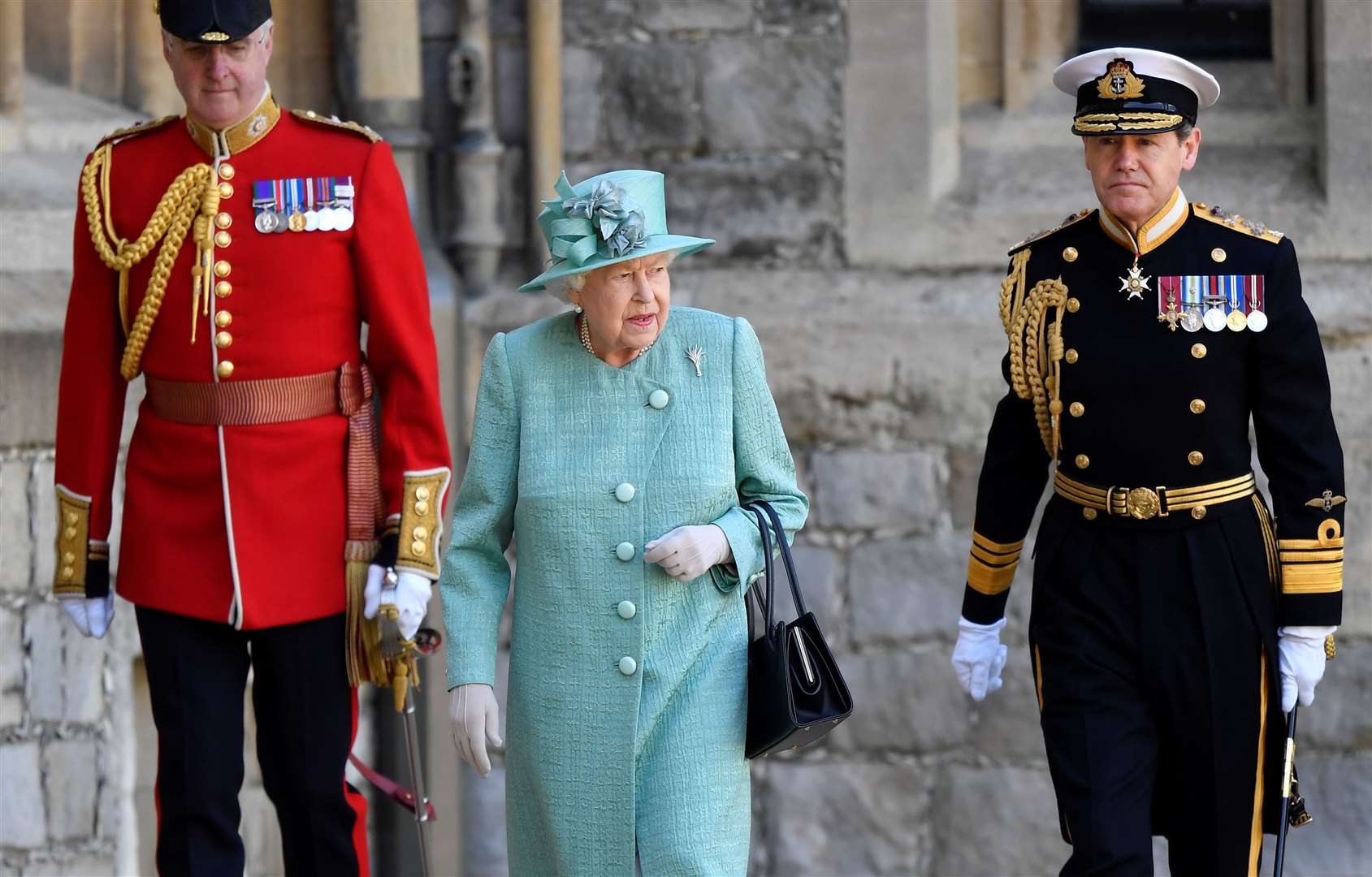 The Queen attended the ‘mini-Trooping’ ceremony flanked by Lieutenant Colonel Michael Vernon, left, and Vice Admiral Sir Tony Johnstone-Burt, right (Toby Melville/PA)