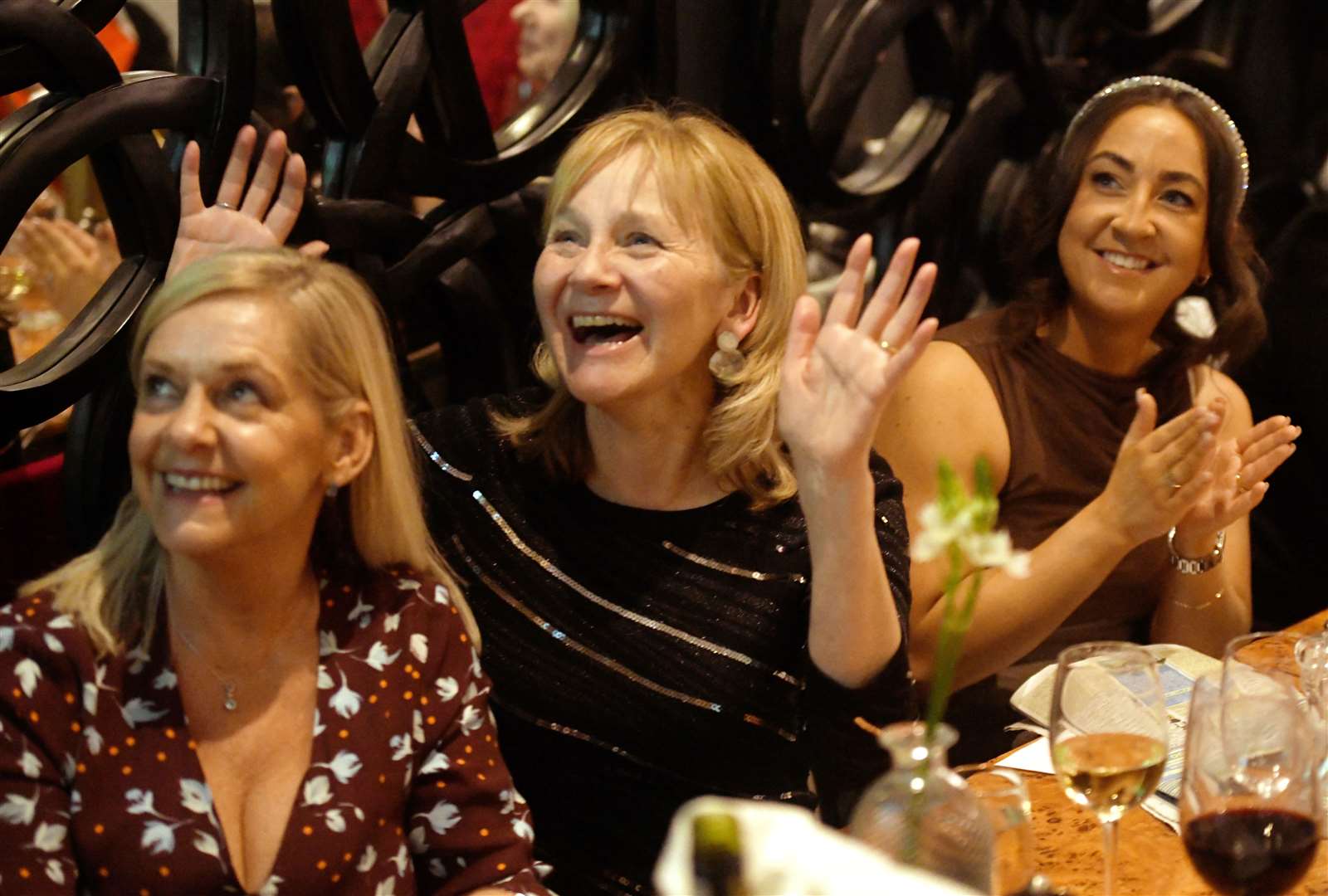Sheila Macdonald, Avril Paton-Mackenzie and Milly Macdonald cheer on their favourites at the Cafe 1 fundraiser to mark Cheltenham Festival race week.