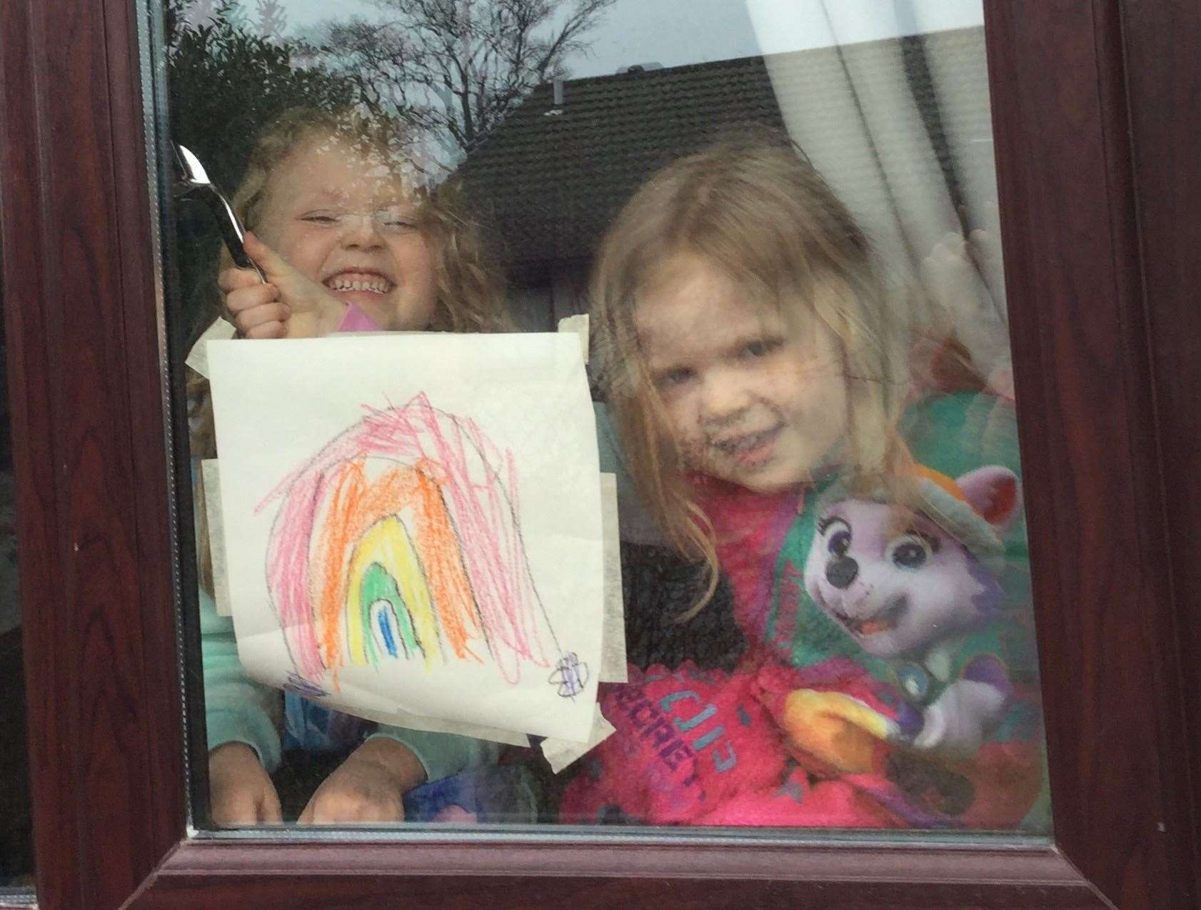 Iona and Emily with a rainbow.